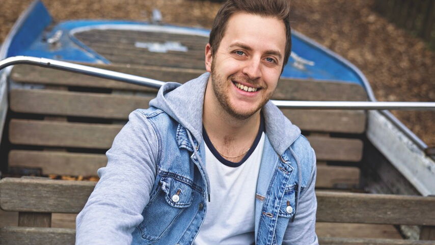 Oliver Rupp sitzt in einem kleinen Boot und hält das Steuer.